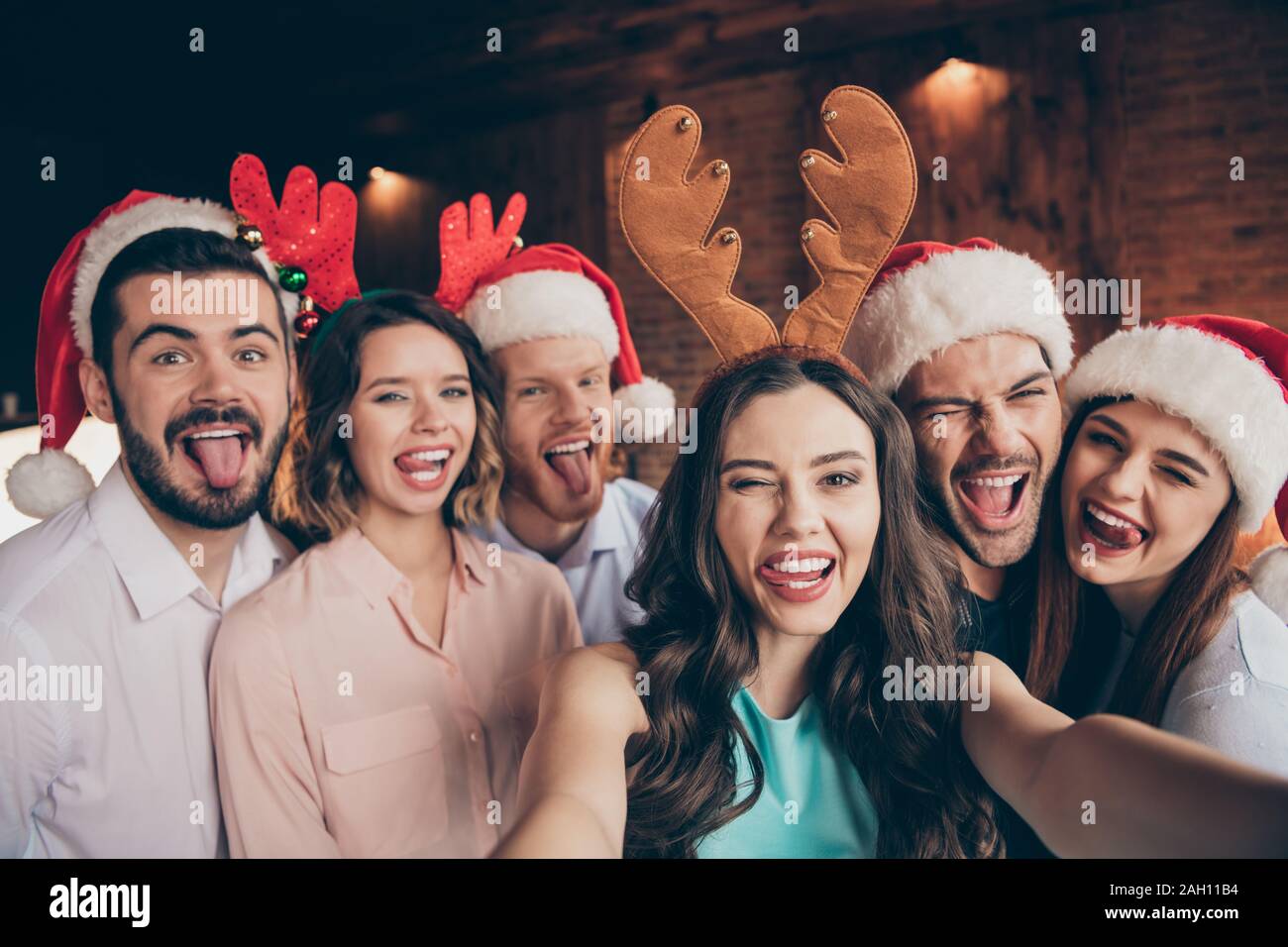 Self-portrait of nice attractive lovely winsome cheerful comic glad childish positive ladies gentlemen having fun showing tongue out lick lips wink Stock Photo