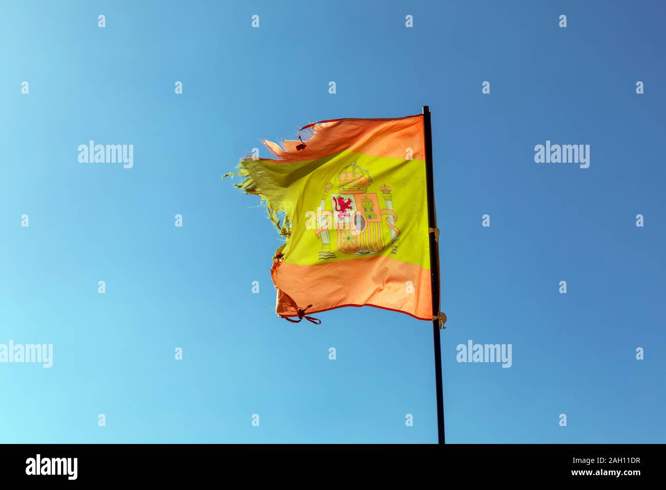 Spanish flag in tatters. Stock Photo