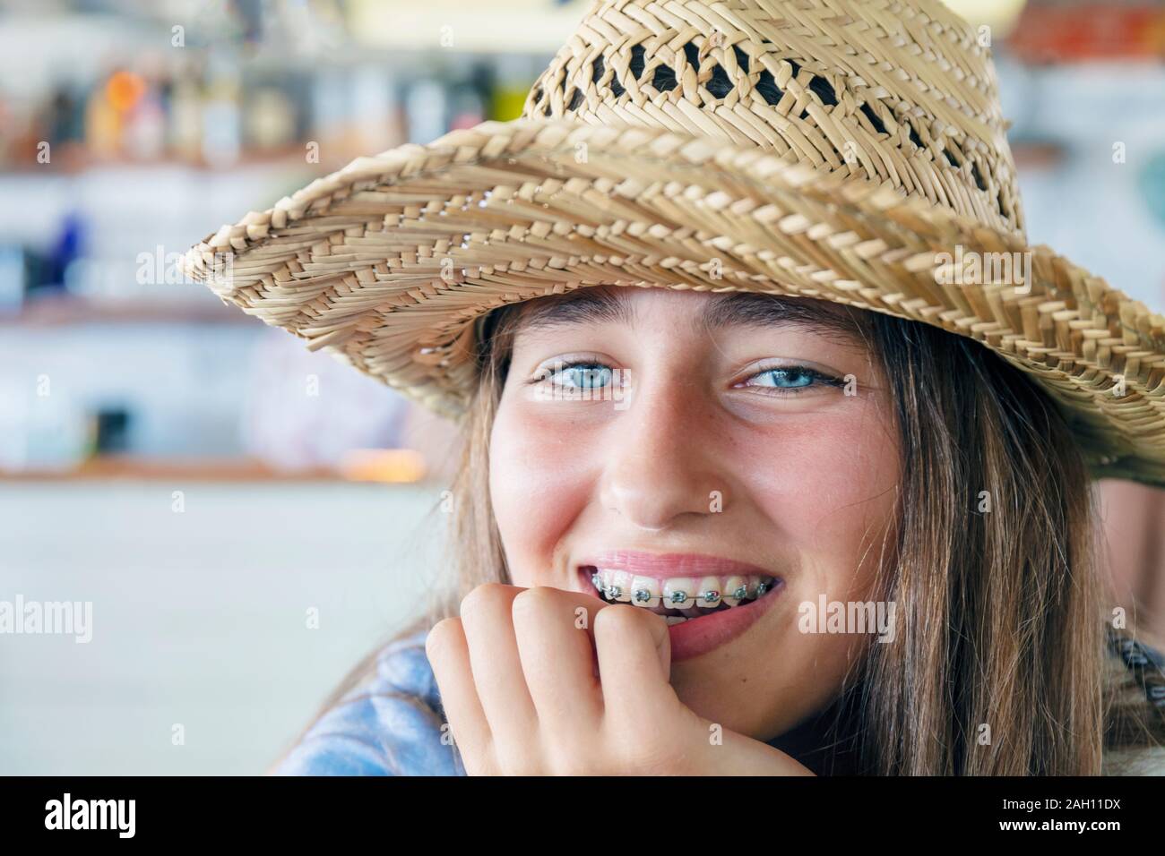 Pre-teen girl smiling directly at camera and showing her orthodontic braces. Stock Photo