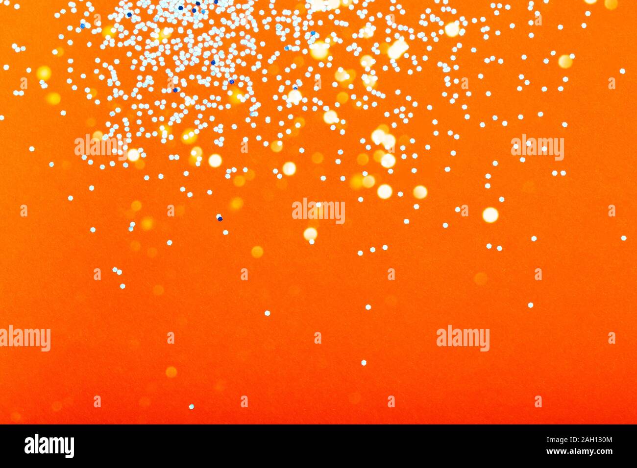 Orange festive background with blue sparkles. The concept of the celebration, the day of St. Valentine, New Year, birthdays, ceremonies, events, etc. Stock Photo