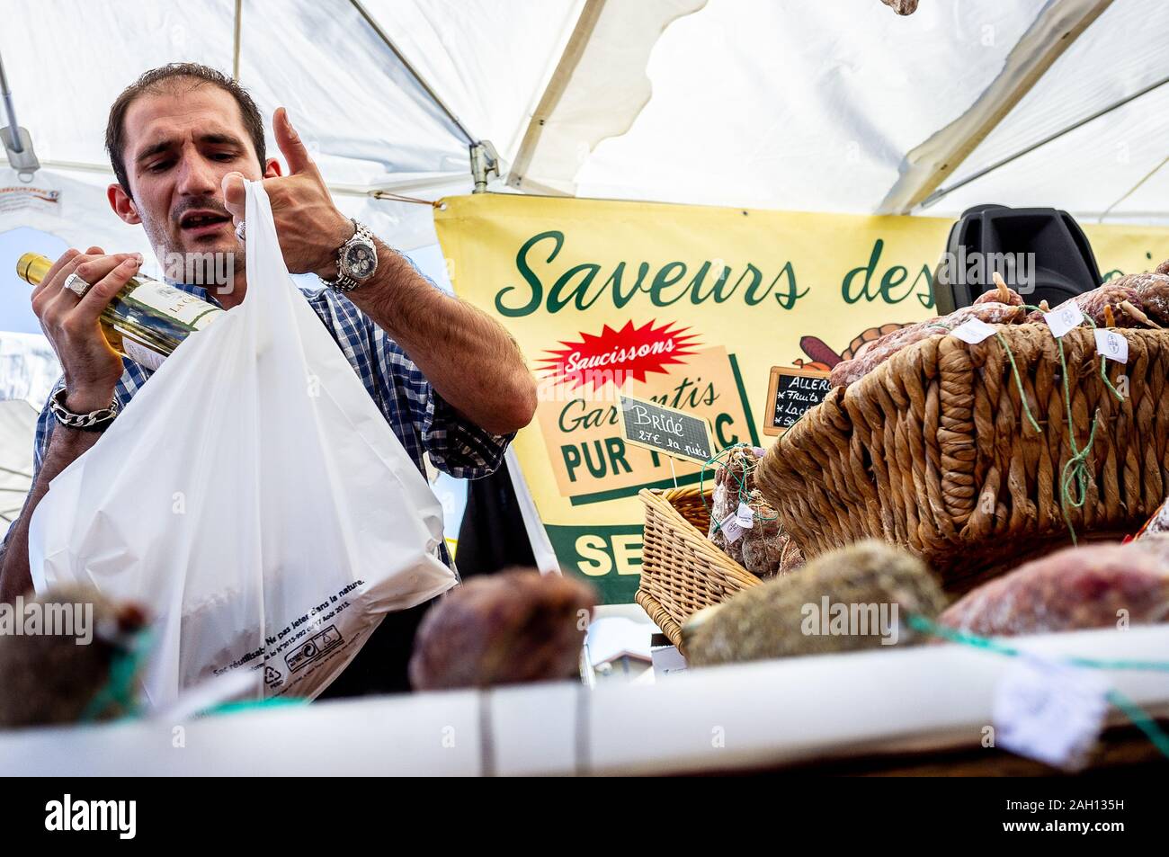 vendor selling local produce on a market in the sun in southern france Stock Photo