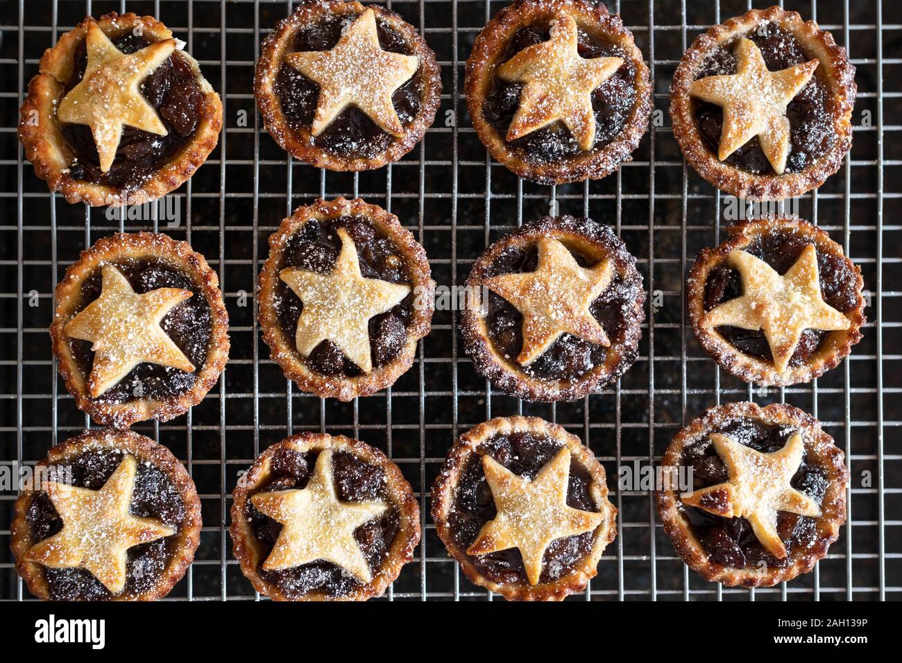 Homemade traditional mince pies on cooling rack Stock Photo