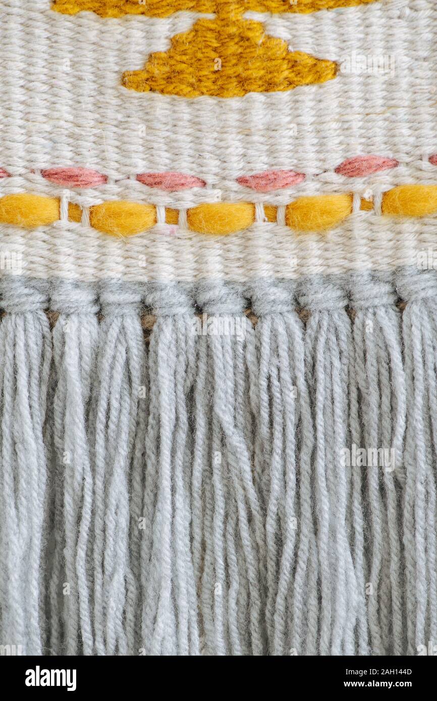 Tight-weaved macrame banner from close distance with treads sewn in a pattern. Stock Photo