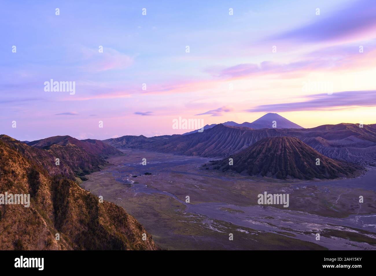 View from above, stunning aerial view of the Mount Batok, Mount Bromo and the Mount Semeru in the distance during a beautiful sunrise. Stock Photo