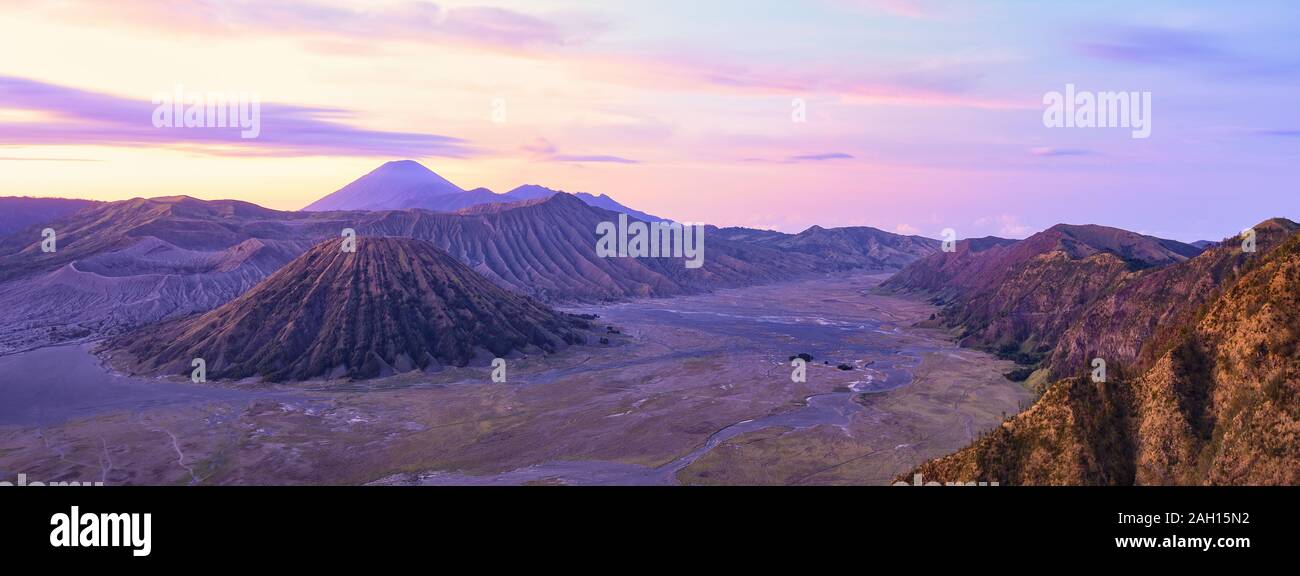 View from above, stunning aerial view of the Mount Batok, Mount Bromo and the Mount Semeru in the distance during a beautiful sunrise. Stock Photo