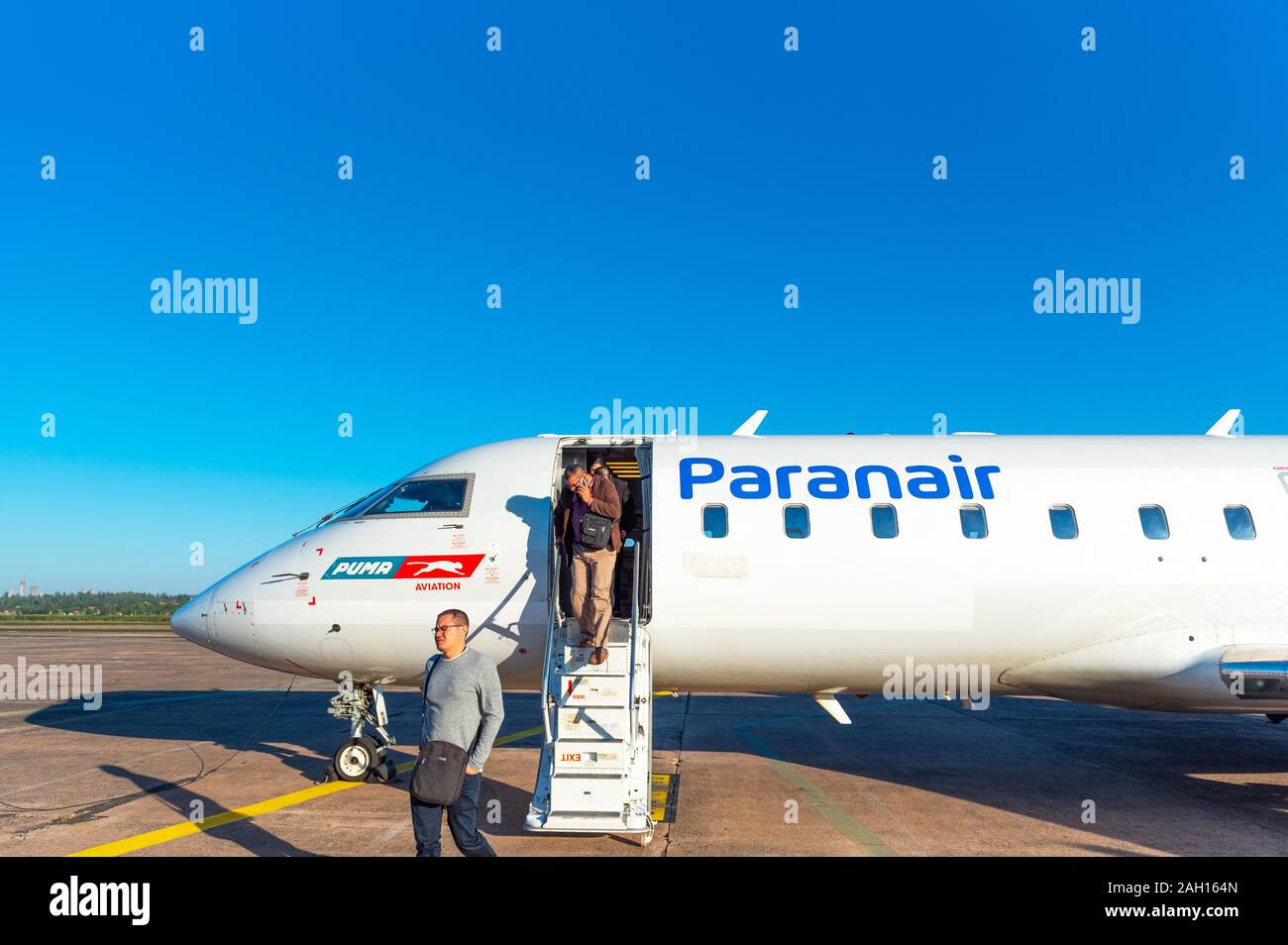 ASUNCION, PARAGUAY - JUNE 24, 2019: Men get off the plane at the airport. Copy space for text Stock Photo