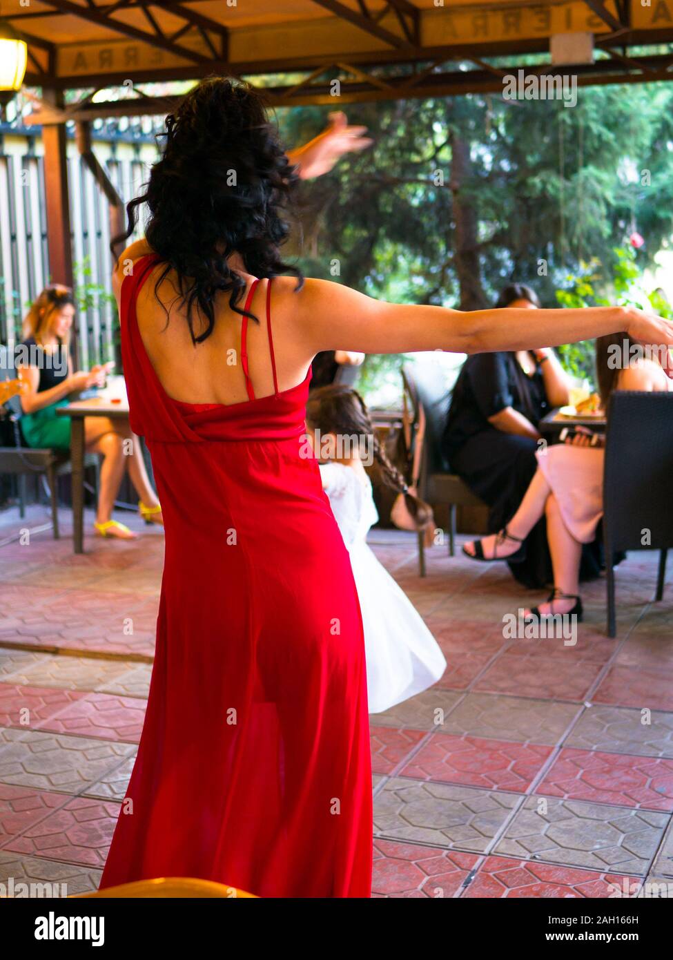 Girl in red dress dancing Stock Photo - Alamy