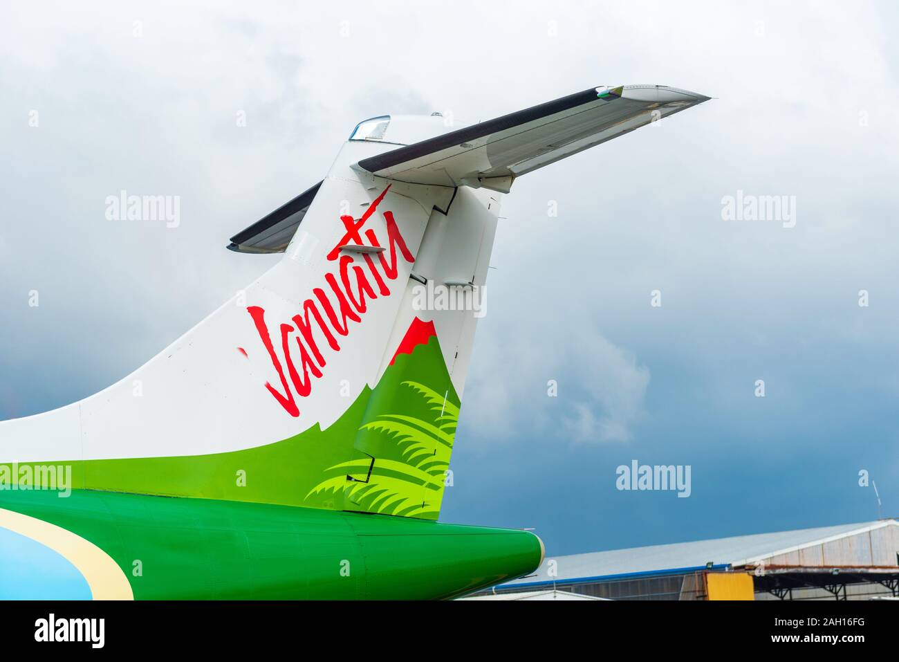 PORTVILA, VANUATU - JULY 19, 2019: The tail of the plane on the cloudy sky background. With selective focus Stock Photo