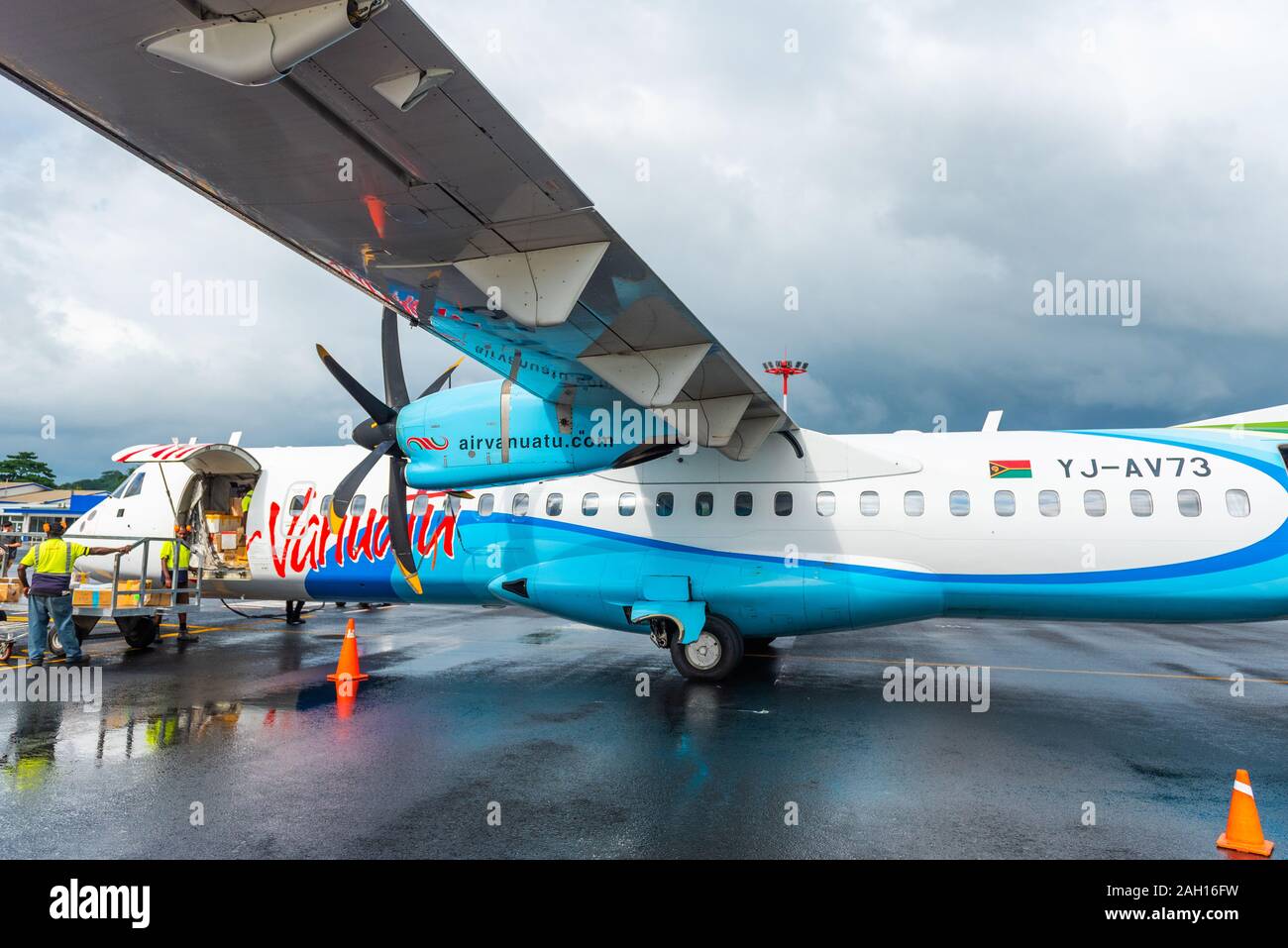 PORTVILA, VANUATU - JULY 19, 2019: Plane at the airport on a background of cloudy sky Stock Photo