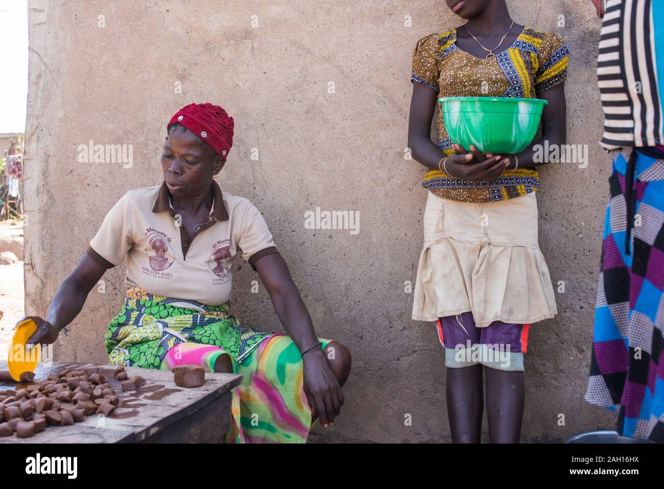 Kandi, Benin, african woman, cooking, open fire, red knit hat, african village, Stock Photo