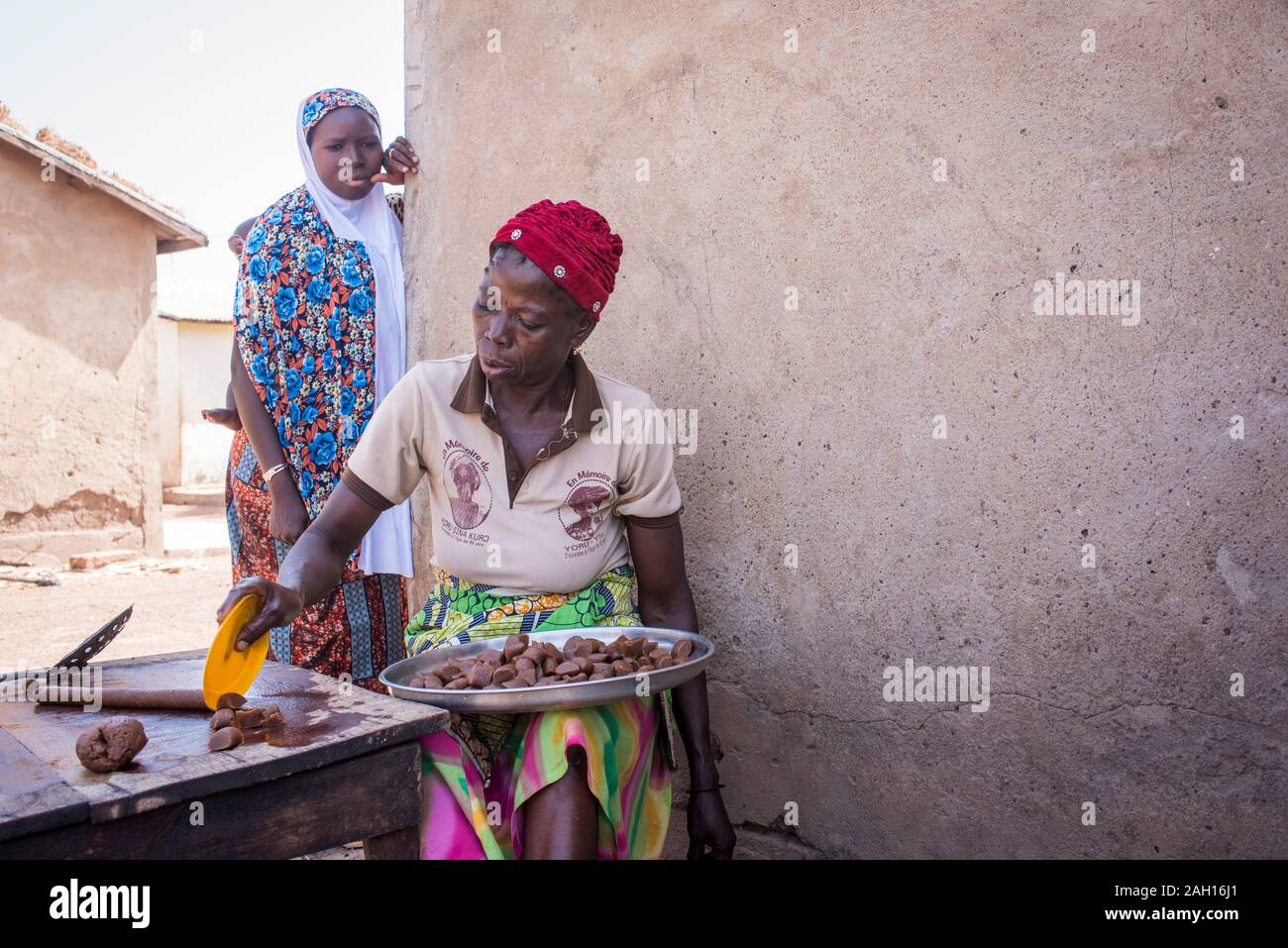 Kandi, Benin, african woman, cooking, open fire, red knit hat, african village, Stock Photo