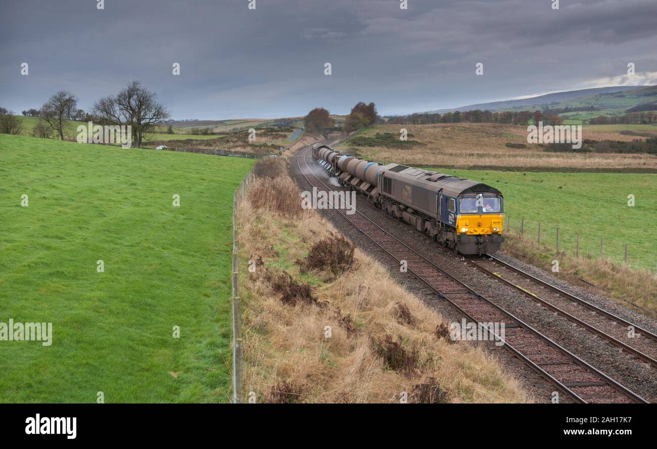 2 Direct rail Services class 66 locomotives hauling a Network Rail water cannon train at Clapham (Yorkshire) dealing with leaves on the line Stock Photo