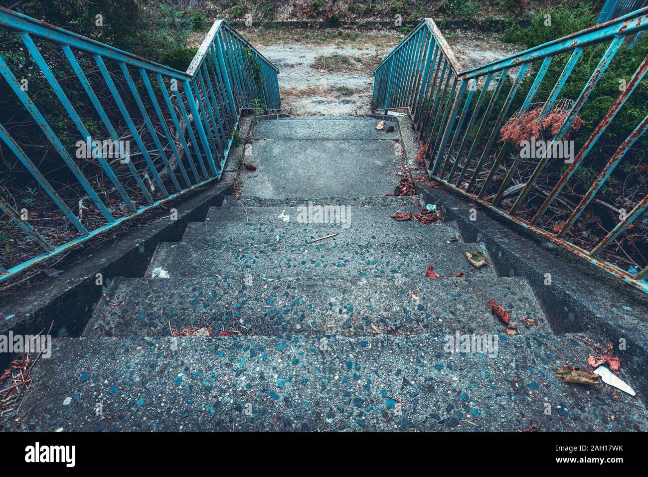 old concrete staircase with rusty blue railing Stock Photo