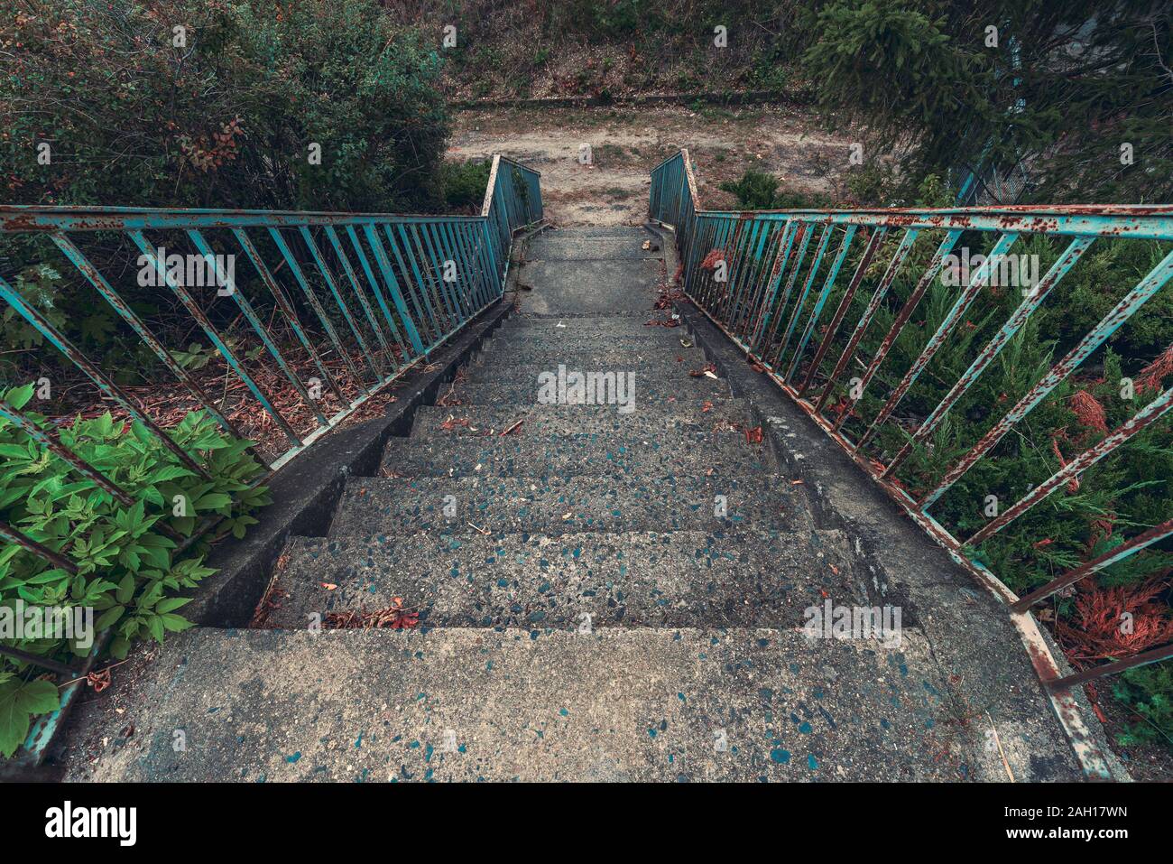 old concrete staircase with rusty blue railing Stock Photo