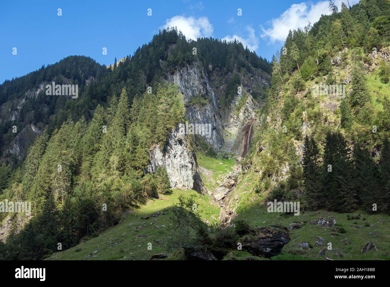 Untersulzbachtal alpine valley, mountainsides. Waterfall. Venediger group. Glacial alpine valley. Hohe Tauern National Park. Austrian Alps. Stock Photo