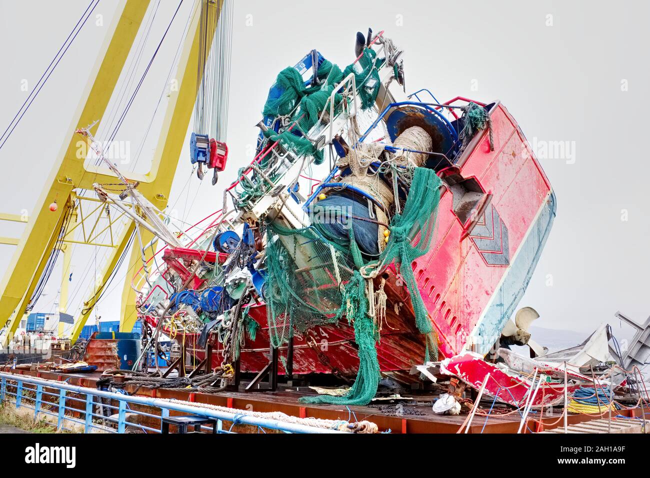 Capsized ship vessel and rescue lift crane at port dock for repair of ...