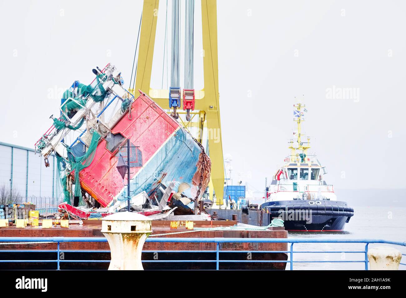 Capsized ship vessel and rescue lift crane at port dock for repair of ...