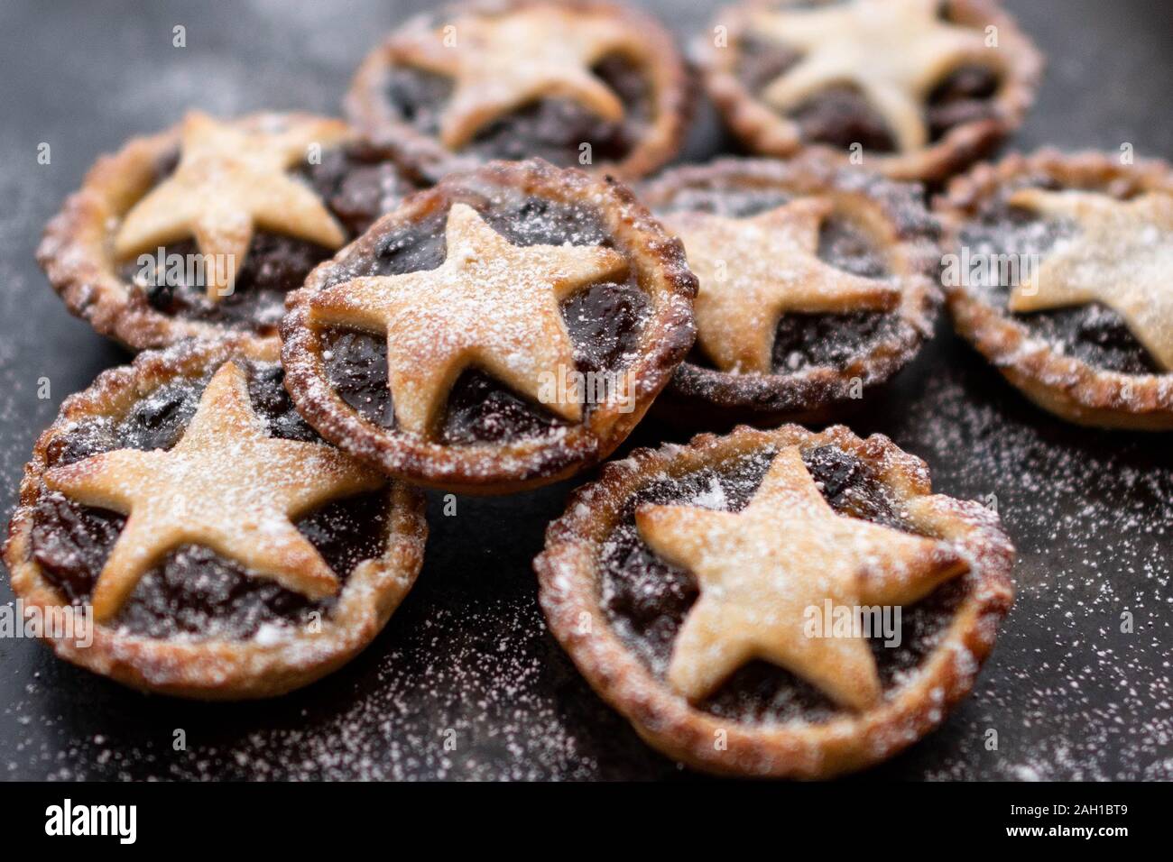 mince pies - homemade with stars and icing sugar on dark background Stock Photo