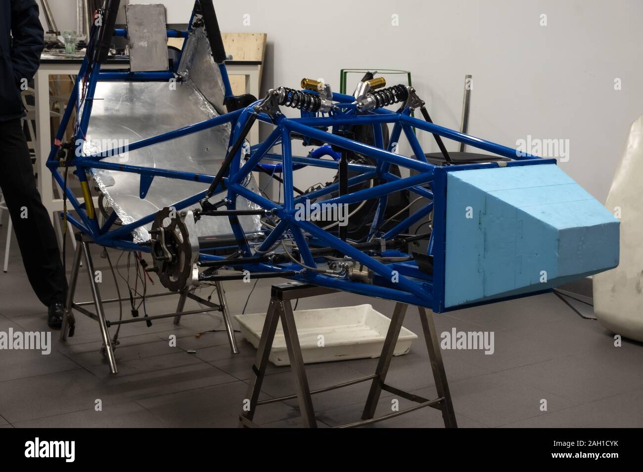 Custom car being build in Sports car body, car frame is assembled by mechanics