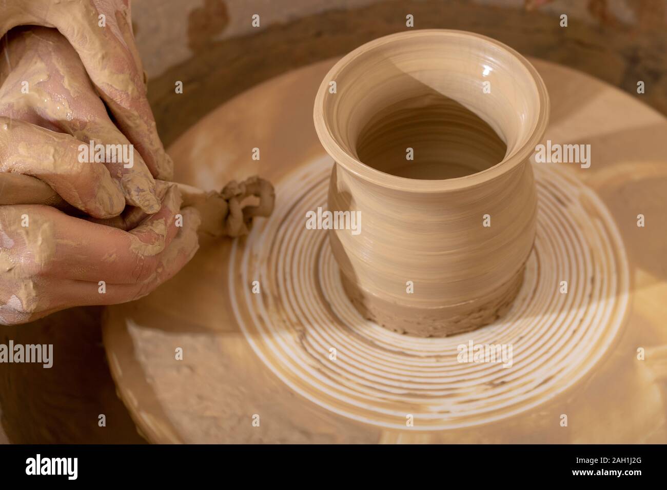 Master class on modeling of clay on a potter's wheel. Unburn pottery jar Stock Photo