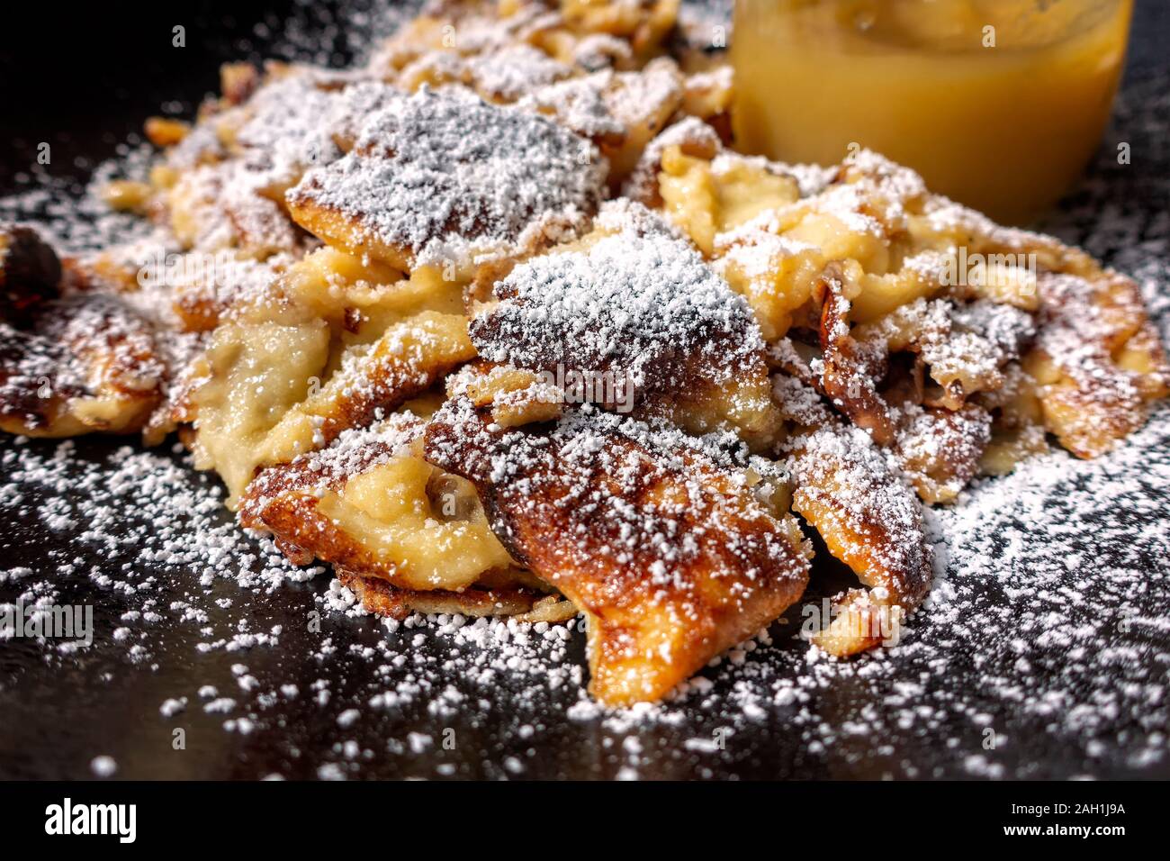 Closeup Of Kaiserschmarrn Scrambled Pancake Sprinkled With Powdered Sugar On Black Plate Shallow Depth Of Field Stock Photo Alamy