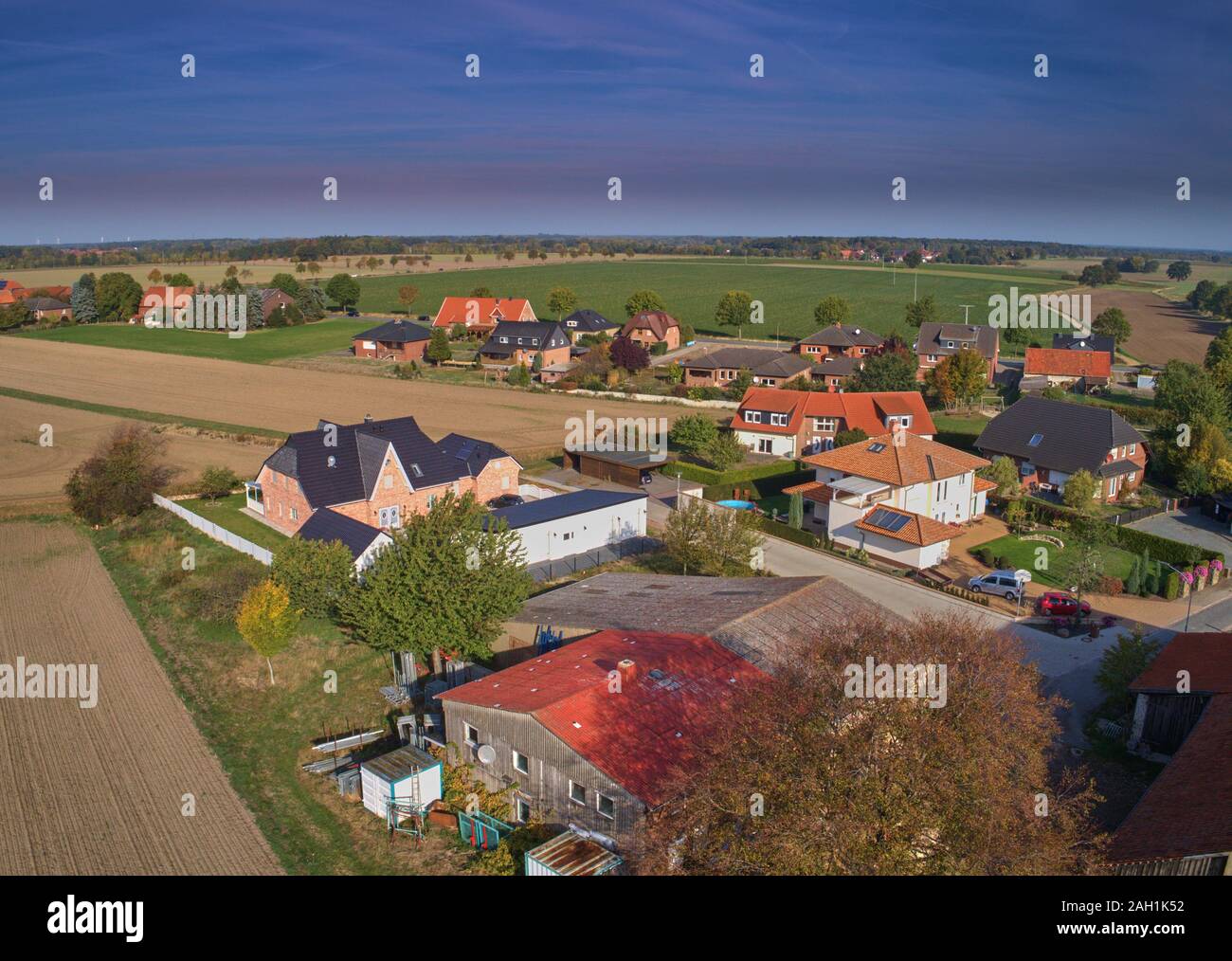 Aerial view of the edge of a settlement with a large shed Stock Photo