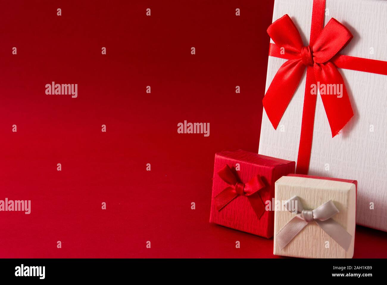 White and red gift boxes on red background. Copy space Stock Photo