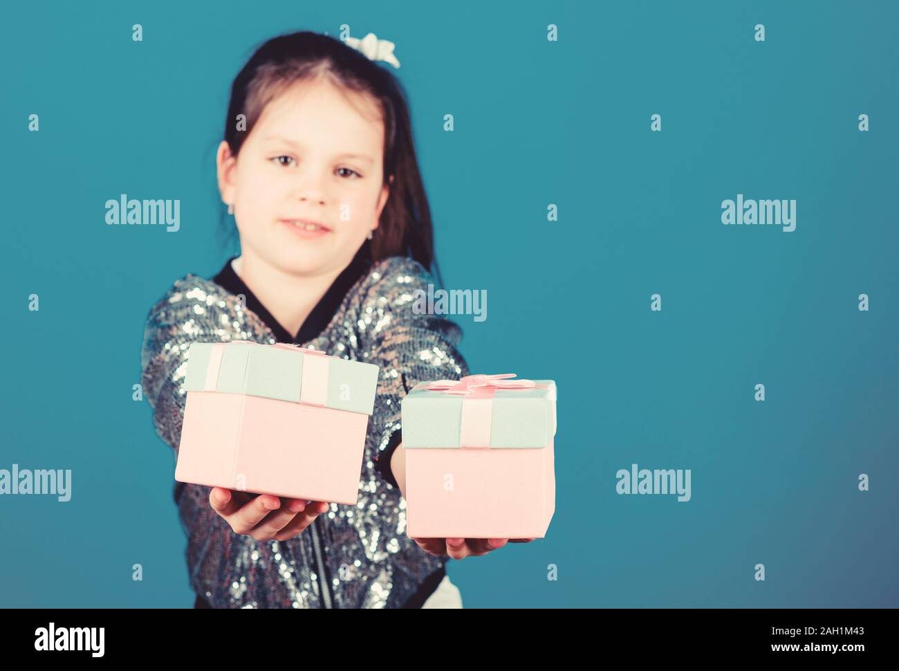 Shopping day. Cute child carry gift boxes. Surprise gift box. Birthday wish list. World of happiness. Special happens every day. Choose one. Girl with gift boxes blue background. Black friday. Stock Photo