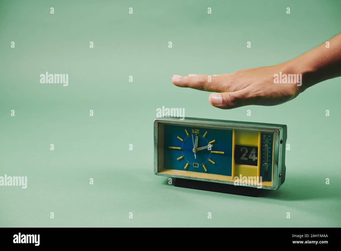 Male hand stopping old fashioned alarm clock Stock Photo Alamy