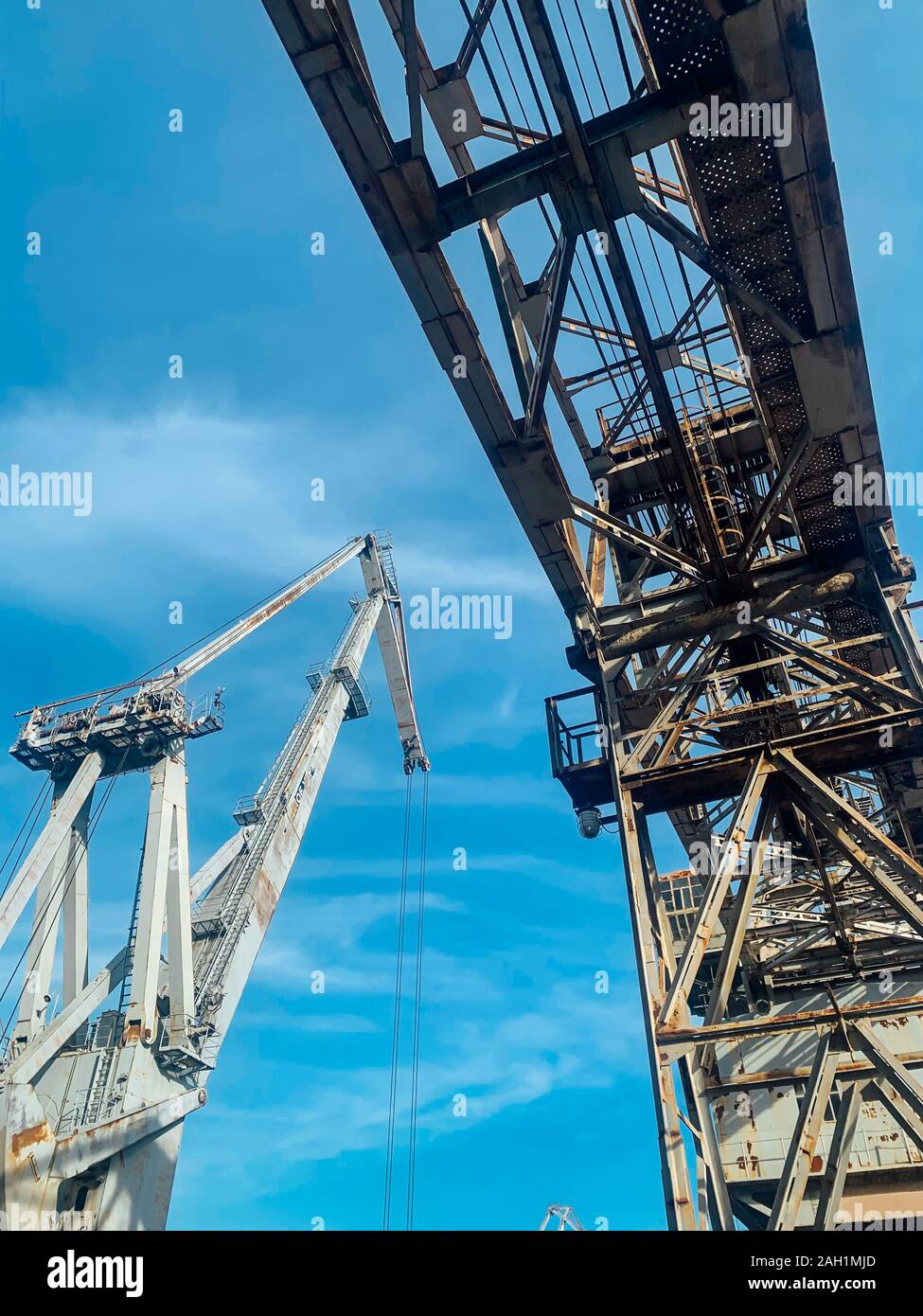 large metal cranes at the plant for lifting cargo Stock Photo