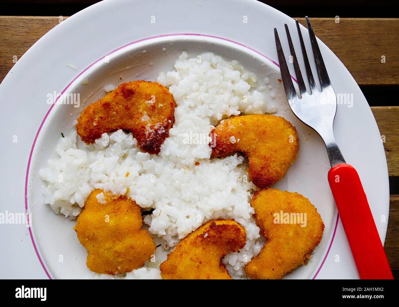 Cooked Breaded chicken nuggets with Rice. Stock Photo