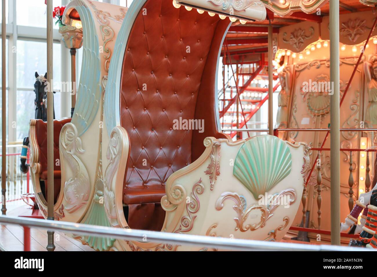 Closeup of passenger chair in a vintage Carousel in a holiday park. Merry-go-round with horses. Stock Photo