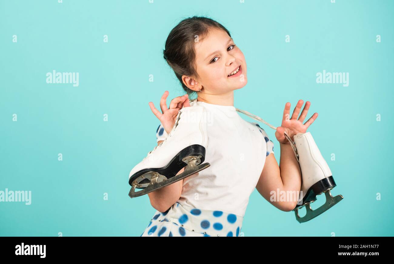 Lets go skating. Happy child with skates hanging on neck. Little girl ...