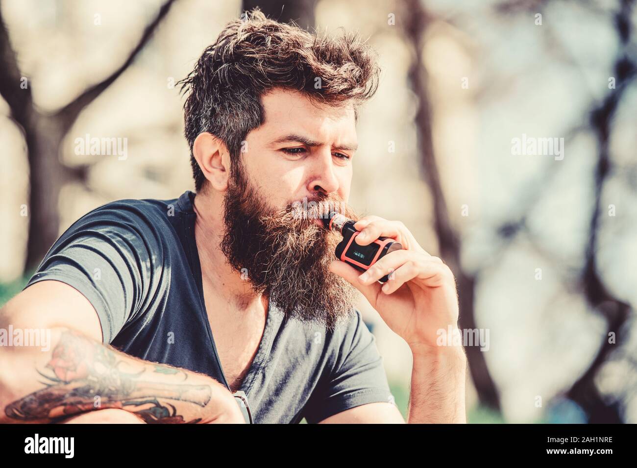 Health safety and addiction. inhaling vapor. Bearded brutal male smoking  electronic cigarette. hipster man hold vaping device. man smoking e- cigarette. Mature hipster with beard. Mr. Expertise Stock Photo - Alamy