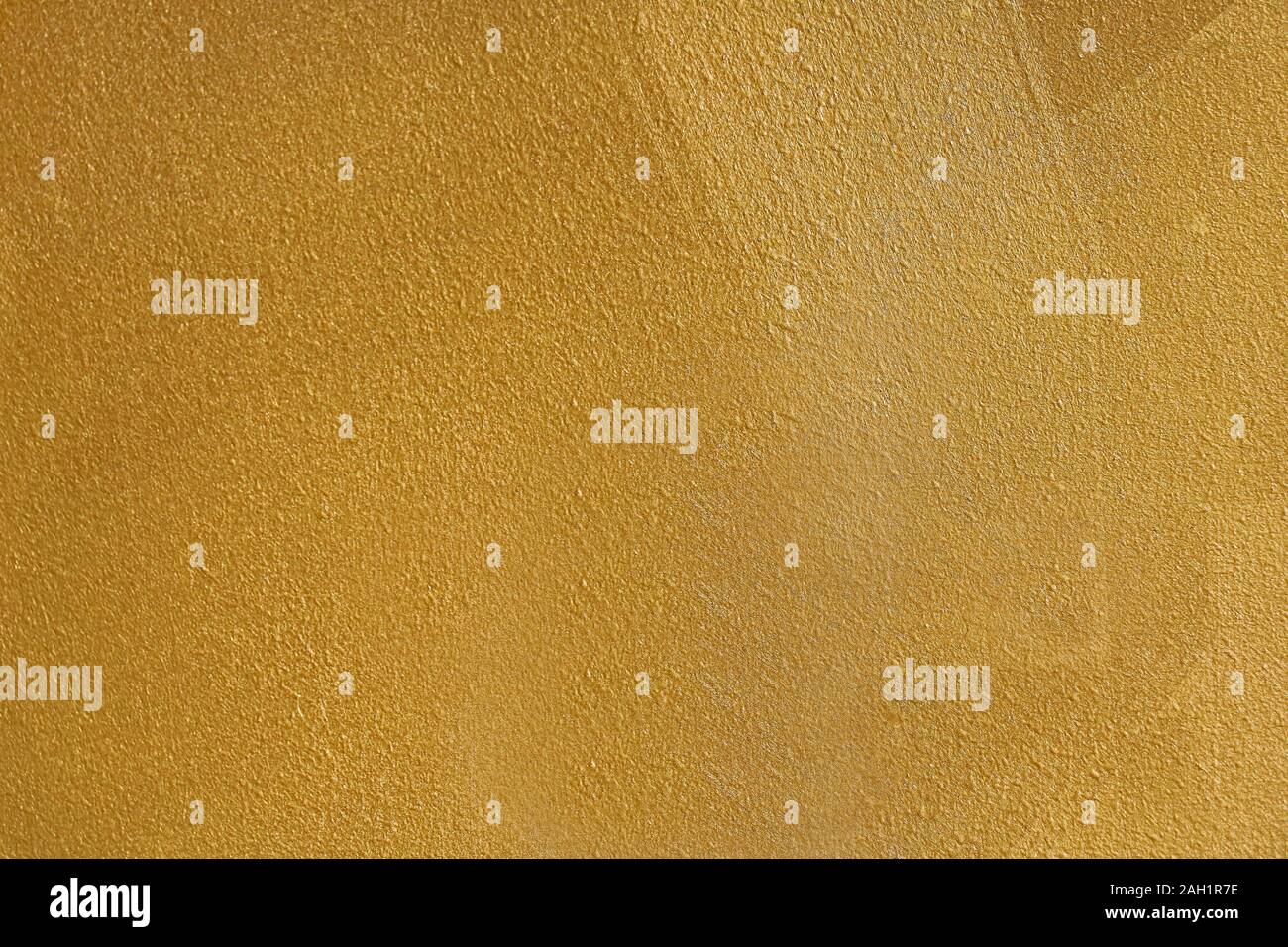 Wall painted in gold color pattern texture background Stock Photo
