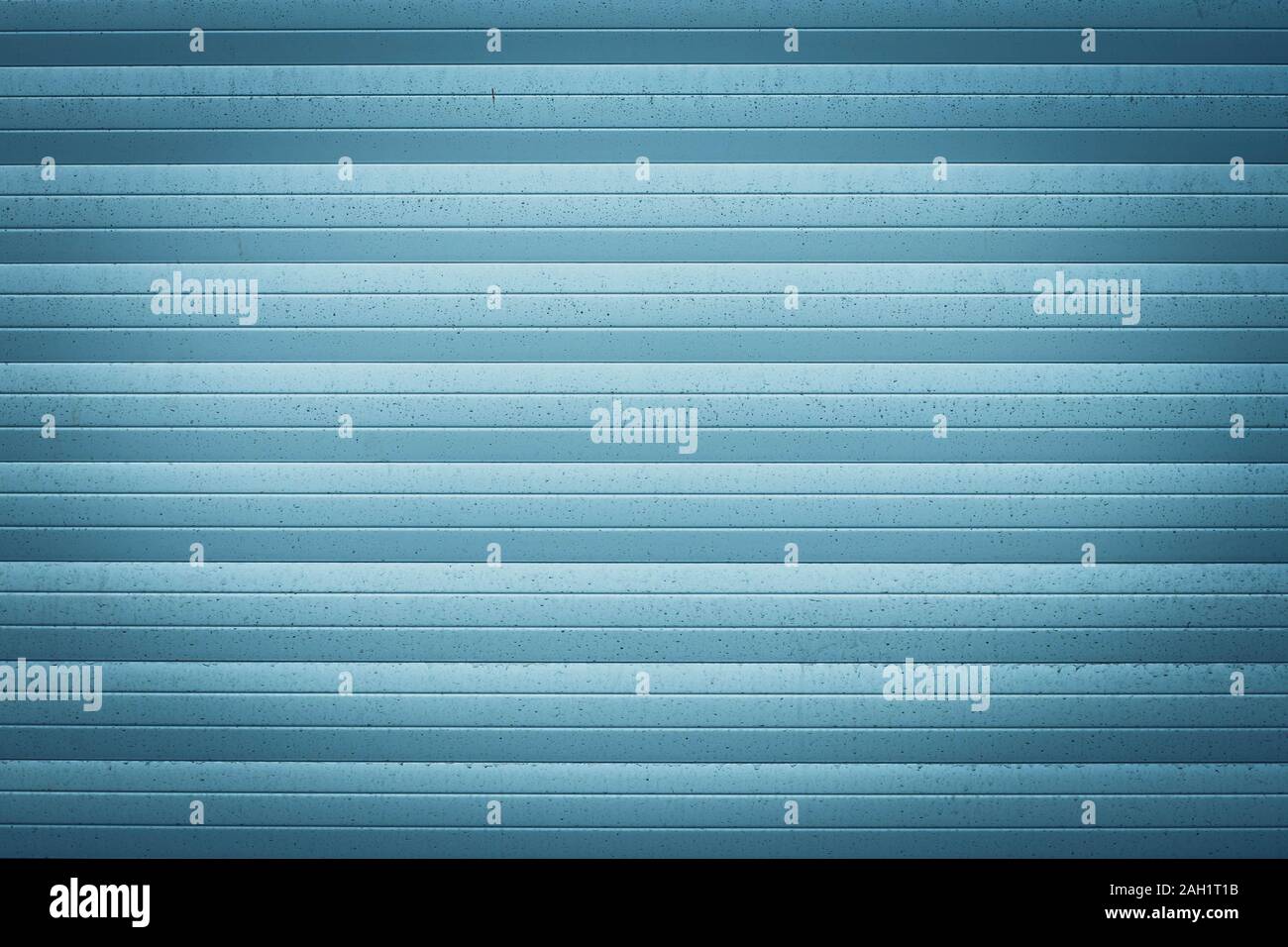 Blue metallic jalousie. Texture of corrugated metal surface. Dirty ribbed background with straight lines. Striped wall, space. Exterior element Stock Photo