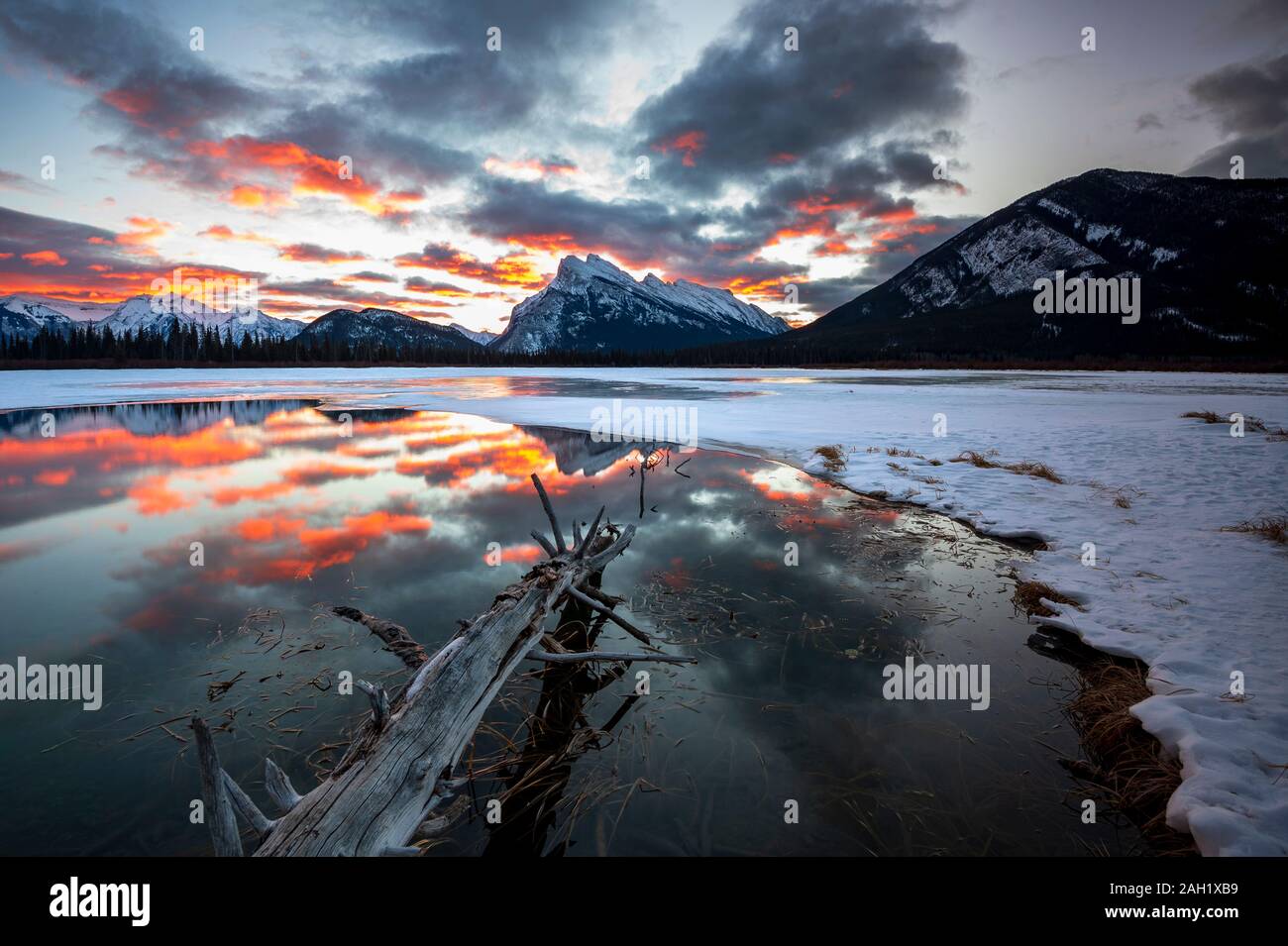 Incredible sunrise reflected in Vermillon Lakes in winter, Banff, Alberta, Canada Stock Photo