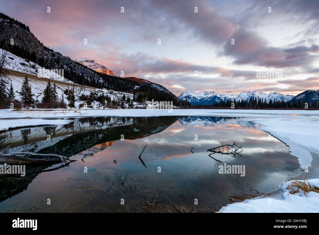 Beautiful sunrise reflected in Vermillon Lakes in winter, Banff, Alberta, Canada Stock Photo