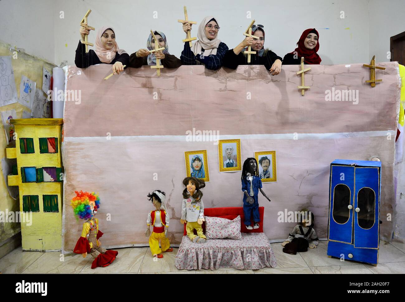Gaza. 23rd Dec, 2019. Palestinian girls show marionettes at Mahdi Karira's office in Gaza City, on Dec. 23, 2019. Mahdi Karira, a 39-year-old master at making the marionette, spent 6 months on training a group of 8 girls and 2 young men to make puppets and perform puppet theater shows for children, in an attempt to promote the art of puppet theater in the Gaza Strip. Credit: Rizek Abdeljawad/Xinhua/Alamy Live News Stock Photo