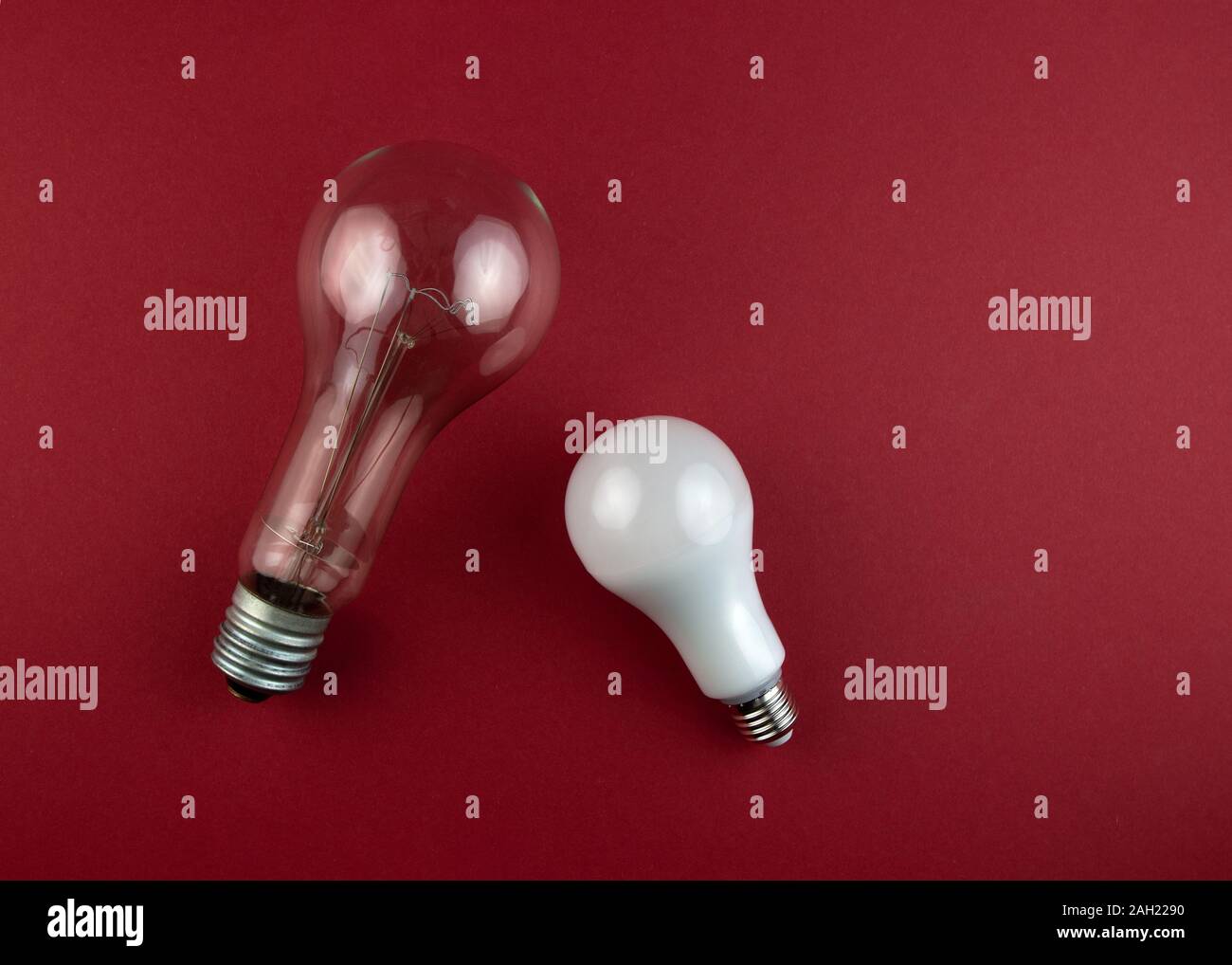 Old incandescent lamp and new led lamp on a brawn background. Energy or