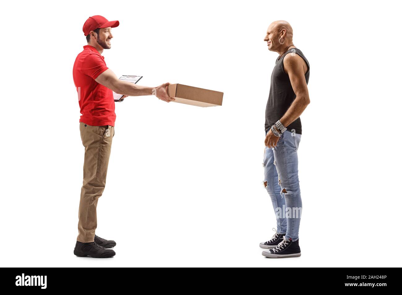 Full length portrait of a postman delivering a package to a male hipster isolated on white background Stock Photo