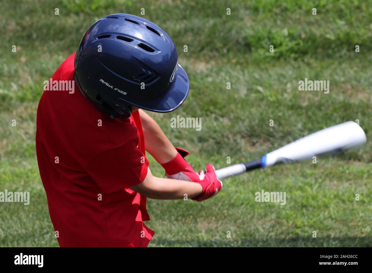 The young baseball player just hit the ball. Stock Photo