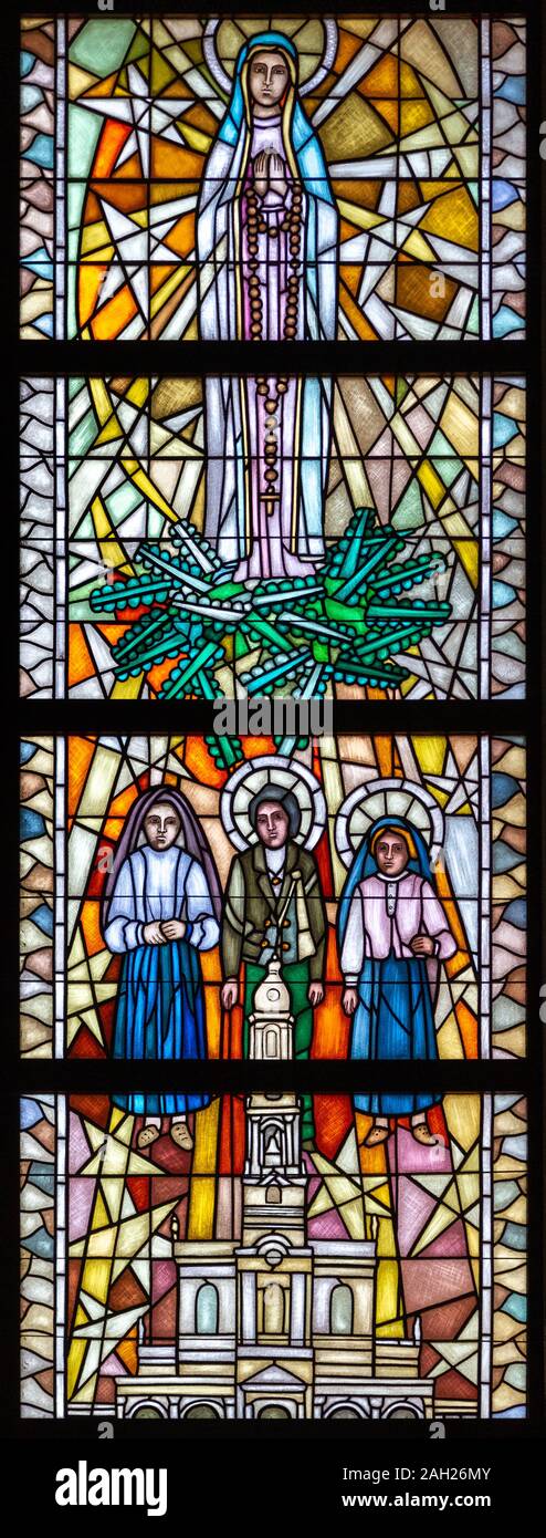 Stained-glass window depicting Our Lady of Fátima with three shepherd children - Lúcia, Jacinta and Francisco. The Sanctuary of Our Lady of Tylicz. Stock Photo