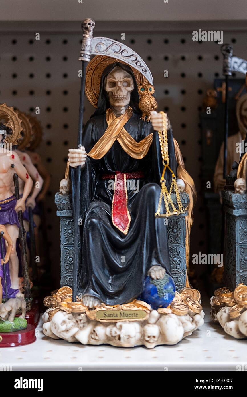 Santa Muerte statues for sale at El Kimbisero Botanica, a store on 37th Avenue Ave selling religious items to a primarily a South American population. Stock Photo