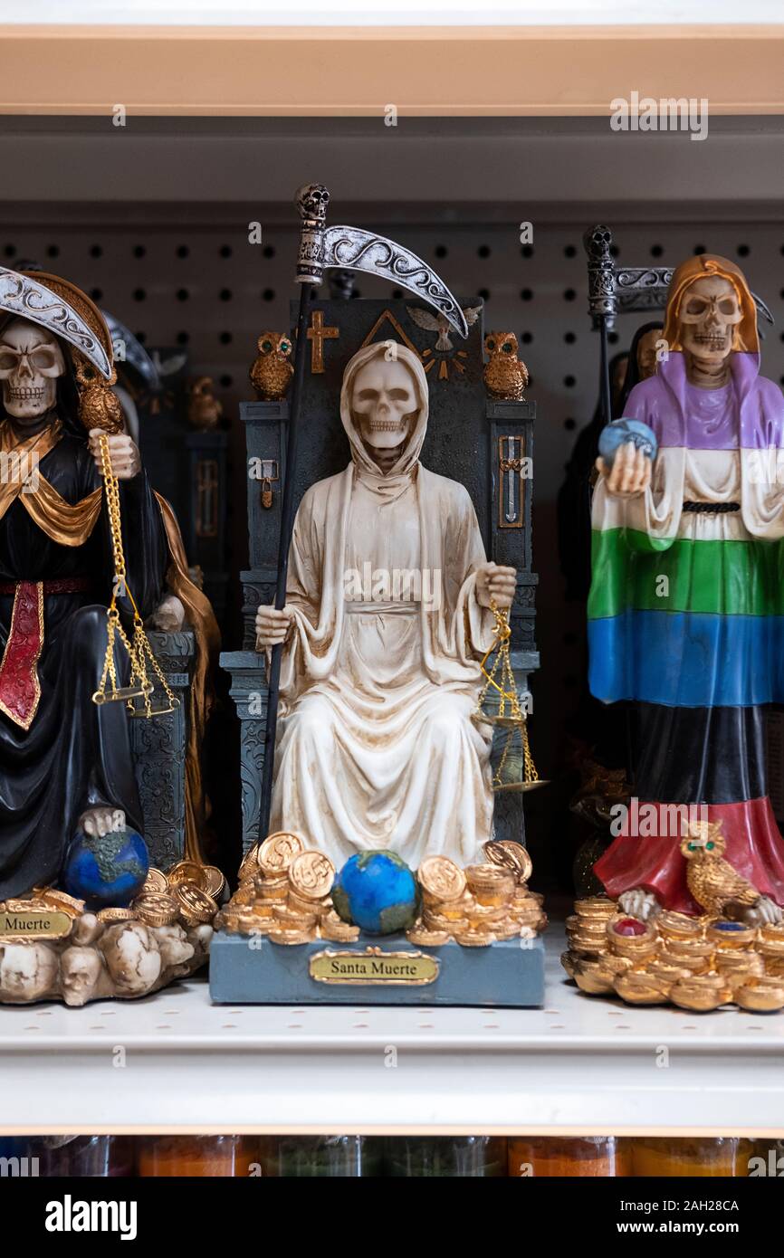 Santa Muerte statues for sale at El Kimbisero Botanica, a store on 37th Avenue Ave selling religious items to a primarily a South American population. Stock Photo