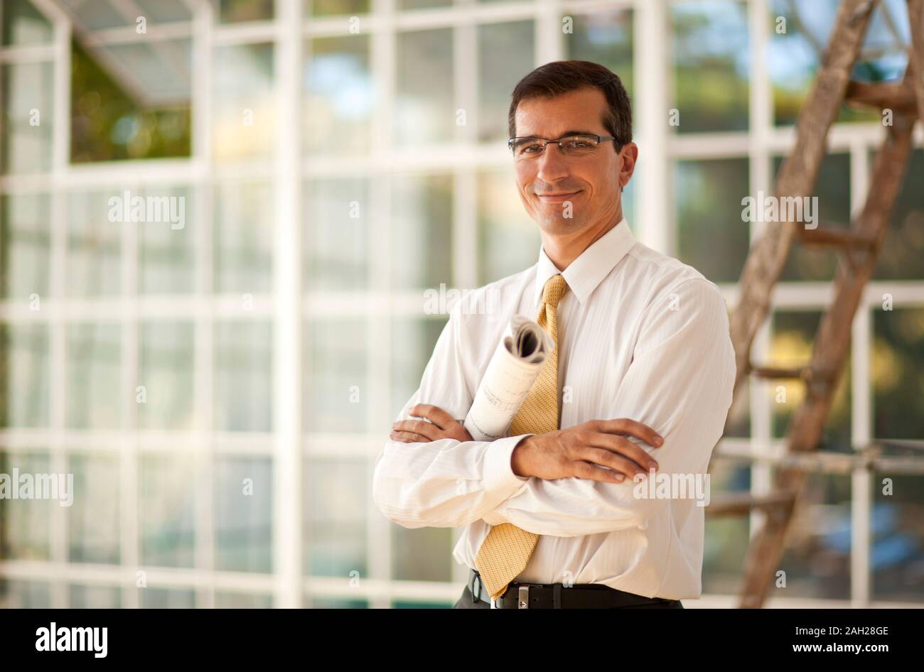 Construction worker writing on a blueprint. Stock Photo