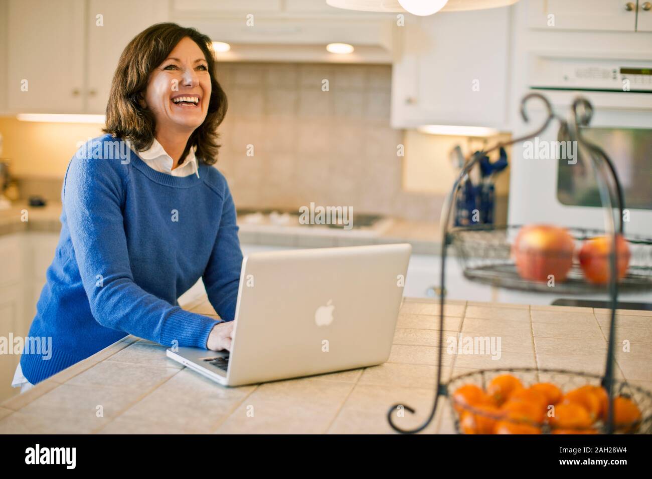 Woman laugh typing on hi-res stock photography and images - Alamy