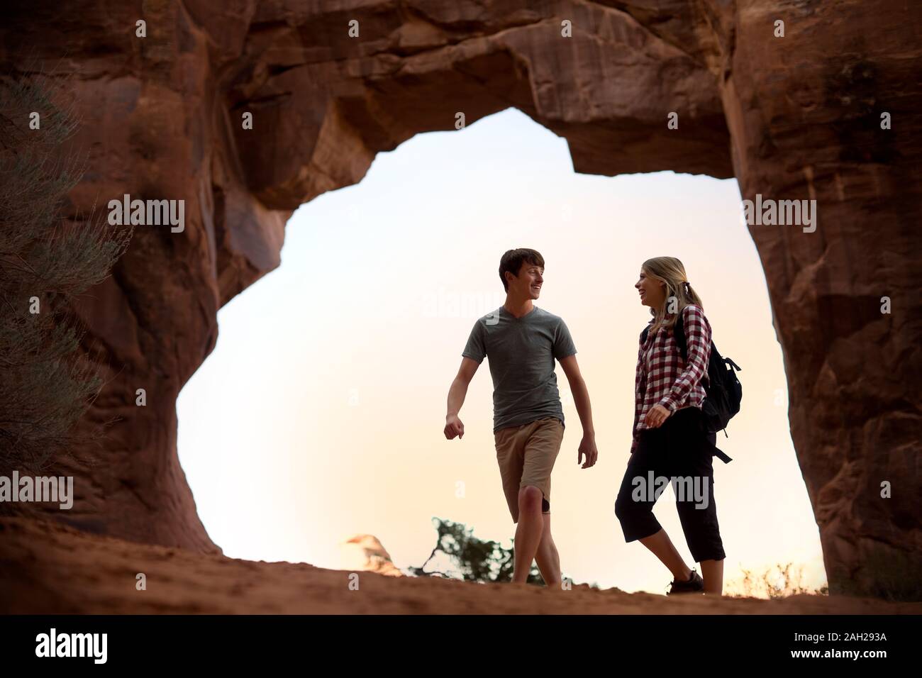 Happy young couple having fun while hiking together in a desert Stock ...