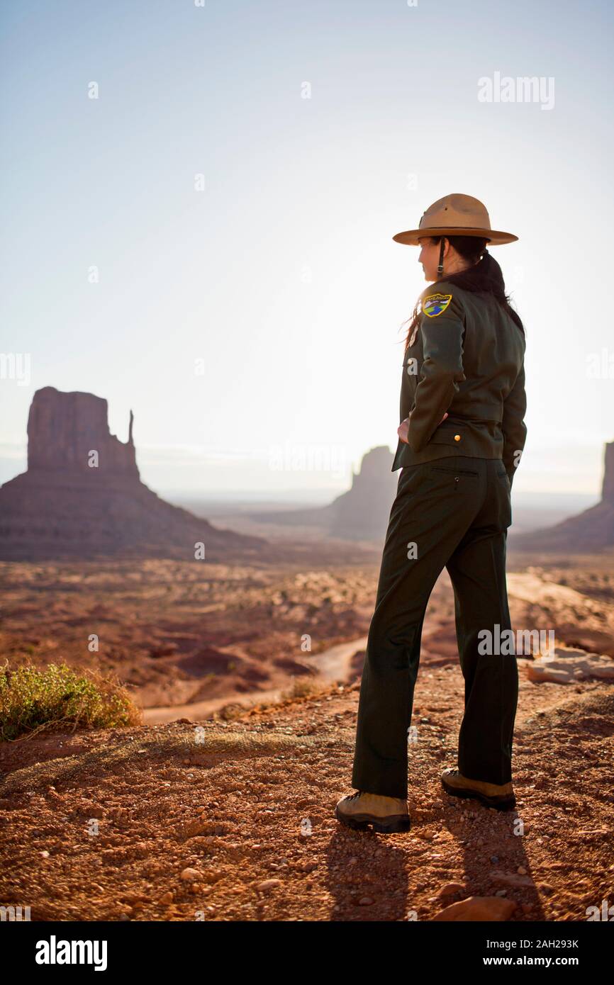 Park ranger looking out over a desert landscape at a national park ...