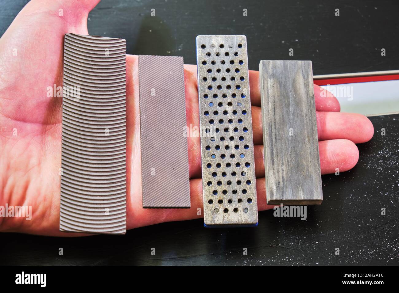 Ski tuning files and stones in a hand: panzar (panzer) file, mill file,  diamond stone, ceramic stone. These are used for ski and snowboard edge  tuning Stock Photo - Alamy